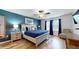 Charming bedroom with a blue accent wall, ceiling fan, and coordinated decor at 8806 Geneve Ct, Kissimmee, FL 34747