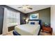 Bedroom featuring a large window, neutral color scheme, and modern furnishings at 8806 Geneve Ct, Kissimmee, FL 34747