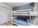 Bedroom featuring white bunk beds with blue bedding and striped pillows at 8806 Geneve Ct, Kissimmee, FL 34747