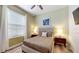 Comfortable bedroom featuring light green walls, a ceiling fan, and a window with blinds at 8806 Geneve Ct, Kissimmee, FL 34747