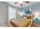 Bedroom with a blue accent wall, ceiling fan, closet, and a full size bed at 8806 Geneve Ct, Kissimmee, FL 34747