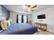 Bright bedroom featuring a cozy bed with blue and white accents, plus stylish wood flooring at 8806 Geneve Ct, Kissimmee, FL 34747