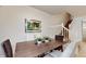 Cozy dining area with a wooden table, decorative plants, and comfortable seating near the staircase at 8806 Geneve Ct, Kissimmee, FL 34747