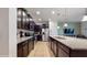 Well-lit kitchen with granite countertops, stainless steel appliances and dark wood cabinets at 8806 Geneve Ct, Kissimmee, FL 34747