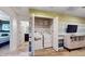 Laundry room with a stacked washer and dryer, storage shelves, and light wood floors at 8806 Geneve Ct, Kissimmee, FL 34747