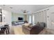 Open-concept living room with tile floors, a stylish fan, and a comfortable leather couch at 8806 Geneve Ct, Kissimmee, FL 34747