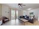 Bright living room with a sliding door to a patio, tile floors, and comfortable seating at 8806 Geneve Ct, Kissimmee, FL 34747