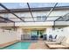 Screened pool area with lounge chairs and patio, perfect for outdoor relaxation and entertainment at 8806 Geneve Ct, Kissimmee, FL 34747