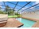 Screened pool area with brick patio and lounge chairs, providing a perfect relaxation space at 8806 Geneve Ct, Kissimmee, FL 34747
