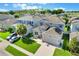 This aerial view shows the property featuring a green lawn, a two-car garage, and nearby neighborhood homes at 965 Maypole Dr, Apopka, FL 32703