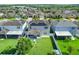 Aerial shot of neighborhood, showcasing a home with solar panels, fenced yard, and proximity to community amenities at 965 Maypole Dr, Apopka, FL 32703