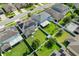 Aerial view of a home displaying a large backyard, screened-in porch, solar panels, and well-maintained landscaping at 965 Maypole Dr, Apopka, FL 32703