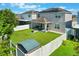 Aerial view of a fenced backyard with a patio, fire pit, shed, and solar panels highlighting outdoor living at 965 Maypole Dr, Apopka, FL 32703