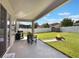 Spacious backyard with covered patio, grill, shed, fire pit, and privacy fence, perfect for outdoor entertaining at 965 Maypole Dr, Apopka, FL 32703