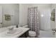 Bright bathroom with a single sink vanity, tub with shower, and neutral-toned decor at 965 Maypole Dr, Apopka, FL 32703