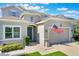 This eye-level view shows the front exterior with a green lawn, inviting curb appeal, and an attached two-car garage at 965 Maypole Dr, Apopka, FL 32703