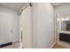 This hallway showcases a sliding barn door and entry to the bathroom at 965 Maypole Dr, Apopka, FL 32703