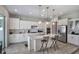 Contemporary kitchen features white cabinetry, a center island with seating, and stainless steel appliances at 965 Maypole Dr, Apopka, FL 32703