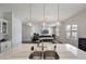 Open kitchen with island sink and pendant lighting provides a seamless transition to the comfortable living area at 965 Maypole Dr, Apopka, FL 32703