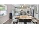 Well-lit kitchen with white cabinets, stainless steel appliances, a center island, and a breakfast table with seating at 965 Maypole Dr, Apopka, FL 32703