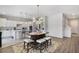 The spacious living area features modern floors, an adjacent dining area, and a kitchen with white cabinets at 965 Maypole Dr, Apopka, FL 32703