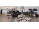 Open-concept living room showcases a cozy black leather couch, contemporary decor, and an adjacent kitchen with modern white cabinetry at 965 Maypole Dr, Apopka, FL 32703