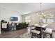Spacious living room with a ceiling fan, dining table set, and a comfortable leather sofa at 965 Maypole Dr, Apopka, FL 32703