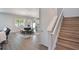 The cozy living area showcases modern floors, dining area, and stairs to the second floor at 965 Maypole Dr, Apopka, FL 32703