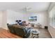 Bright living room features an entertainment area with a wall-mounted TV, along with a desk space and modern furnishings at 965 Maypole Dr, Apopka, FL 32703