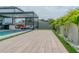 Well-maintained backyard featuring a sparkling pool, a comfortable lounge area, and beautiful landscaping at 9863 Summerlake Groves St, Winter Garden, FL 34787