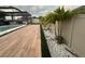 Serene backyard showcasing a modern pool, lush landscaping, and a stylish outdoor lounge area for relaxation at 9863 Summerlake Groves St, Winter Garden, FL 34787