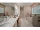 Bright bathroom features double sinks, a soaking tub, a separate shower, and tons of counter space at 9863 Summerlake Groves St, Winter Garden, FL 34787