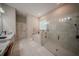 This large bathroom features double sinks, a walk in shower, and a soaking tub with a window at 9863 Summerlake Groves St, Winter Garden, FL 34787