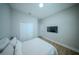 Neutral bedroom featuring hardwood floors, a mounted television, and a double door closet at 9863 Summerlake Groves St, Winter Garden, FL 34787