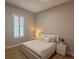 Inviting bedroom with light walls, modern furnishings, and a window with white shutters at 9863 Summerlake Groves St, Winter Garden, FL 34787