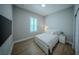 Modern bedroom with light wood flooring, plantation shutters, and a sleek, minimalist design at 9863 Summerlake Groves St, Winter Garden, FL 34787