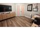 Bonus room with a TV, desk and wood-look flooring at 9863 Summerlake Groves St, Winter Garden, FL 34787