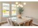 Elegant dining room with modern chandelier and a view of the pool at 9863 Summerlake Groves St, Winter Garden, FL 34787