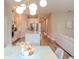 Bright dining room with modern chandelier, seating for six, and hardwood floors at 9863 Summerlake Groves St, Winter Garden, FL 34787