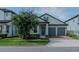 Charming single-Gathering home with a well-manicured lawn, a two-car garage, and a welcoming front porch at 9863 Summerlake Groves St, Winter Garden, FL 34787