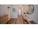 Stylish hallway with hardwood flooring, modern decor, and a glimpse of the home's spacious interior at 9863 Summerlake Groves St, Winter Garden, FL 34787