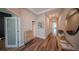 Well-lit hallway featuring hardwood floors, decorative accents, and a clear view of the home's layout at 9863 Summerlake Groves St, Winter Garden, FL 34787