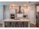 Bright kitchen with white cabinets, stainless appliances, a large center island and bar stool seating at 9863 Summerlake Groves St, Winter Garden, FL 34787