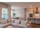Open-concept living room and kitchen with a neutral color palette and hardwood floors offer an inviting space at 9863 Summerlake Groves St, Winter Garden, FL 34787