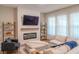 Bright and airy living room with a fireplace and decorative shelving at 9863 Summerlake Groves St, Winter Garden, FL 34787