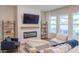 Cozy living room with fireplace, comfortable seating, lots of natural light and modern decor at 9863 Summerlake Groves St, Winter Garden, FL 34787
