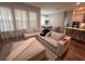 Inviting living room featuring an open floor plan with hardwood floors and large windows at 9863 Summerlake Groves St, Winter Garden, FL 34787