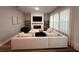 Cozy living area with a fireplace, built-in shelves, a modular sofa, and large windows with sheer curtains at 9863 Summerlake Groves St, Winter Garden, FL 34787