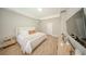 Serene primary bedroom with modern furniture and hardwood floors at 9863 Summerlake Groves St, Winter Garden, FL 34787