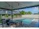 Backyard oasis featuring a pristine pool, a relaxing lounge area, and lush landscaping for ultimate privacy at 9863 Summerlake Groves St, Winter Garden, FL 34787